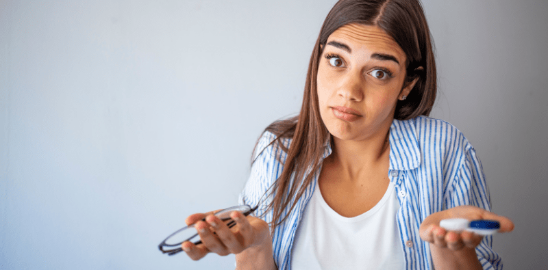 A lady deciding if she should opt for glasses or contact lenses