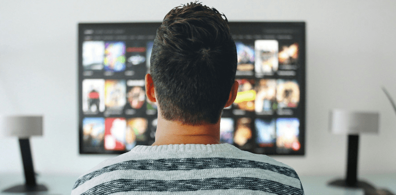 A man watching at home watching TV
